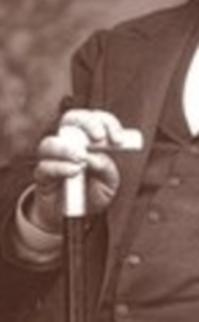 Close-up of Charles Spurgeon with a cane displaying the Vulcan Hand Signal. 